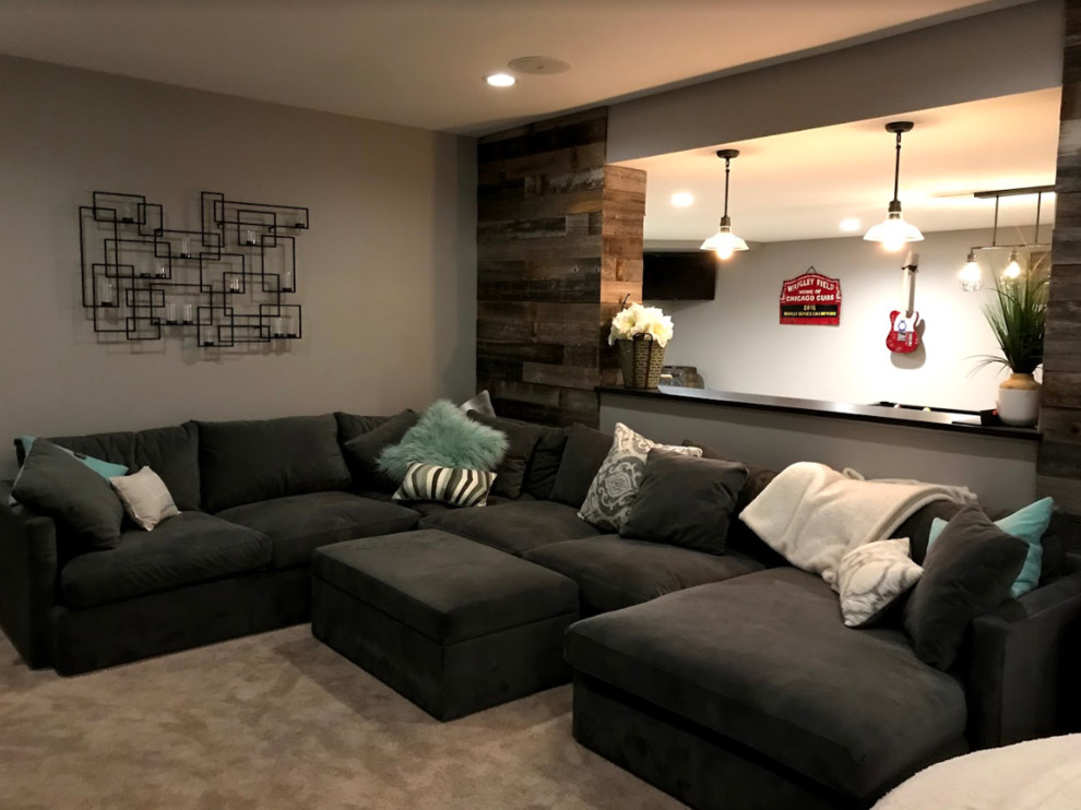 Inspiration for a large transitional underground carpeted and beige floor basement remodel in Other with beige walls, a standard fireplace and a metal fireplace