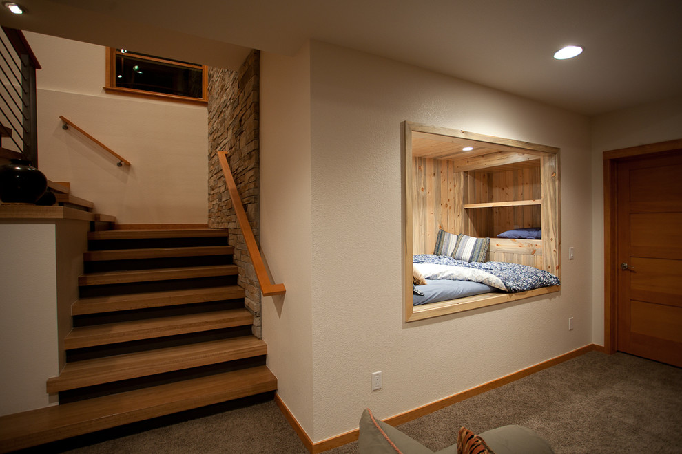 Inspiration for a modern basement in Denver with beige walls, carpet and grey floors.