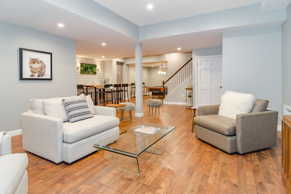 This is an example of a large contemporary look-out basement in Newark with grey walls, vinyl flooring, no fireplace and brown floors.