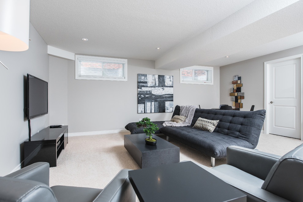 Inspiration for a large modern underground carpeted basement remodel in Toronto with gray walls and no fireplace