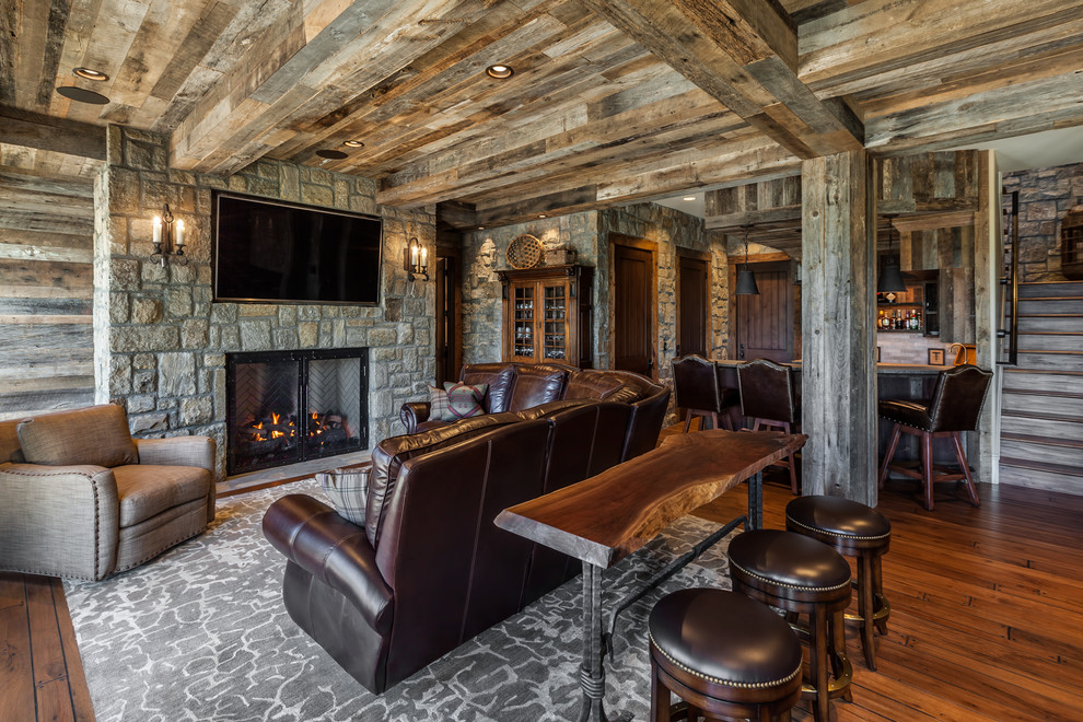 Photo of a rustic living room in Other with medium hardwood flooring, a standard fireplace and a stone fireplace surround.