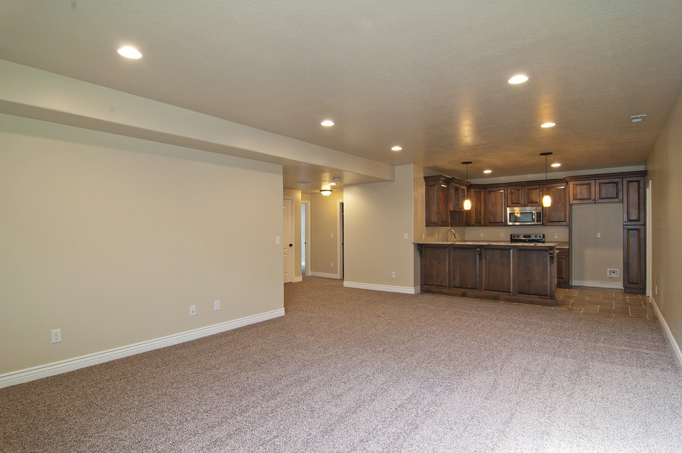Inspiration for a large timeless look-out carpeted basement remodel in Salt Lake City with beige walls and no fireplace
