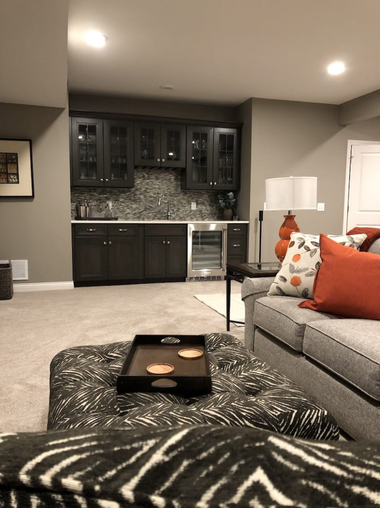 This is an example of a medium sized contemporary basement in Cleveland with grey walls, carpet and beige floors.