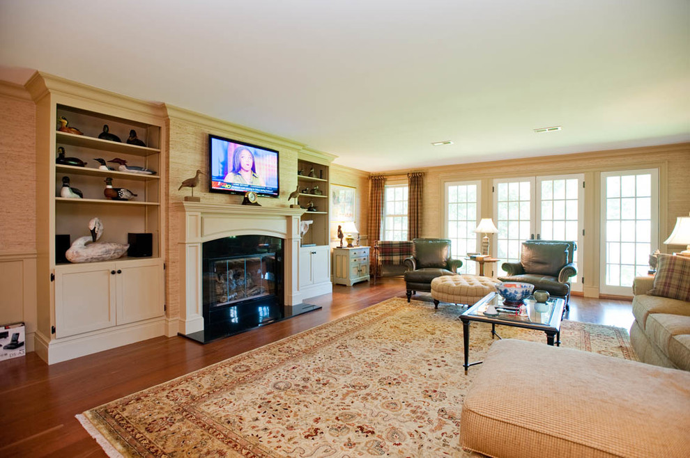 This is an example of a large walk-out basement in New York with beige walls, medium hardwood flooring, a standard fireplace and a tiled fireplace surround.
