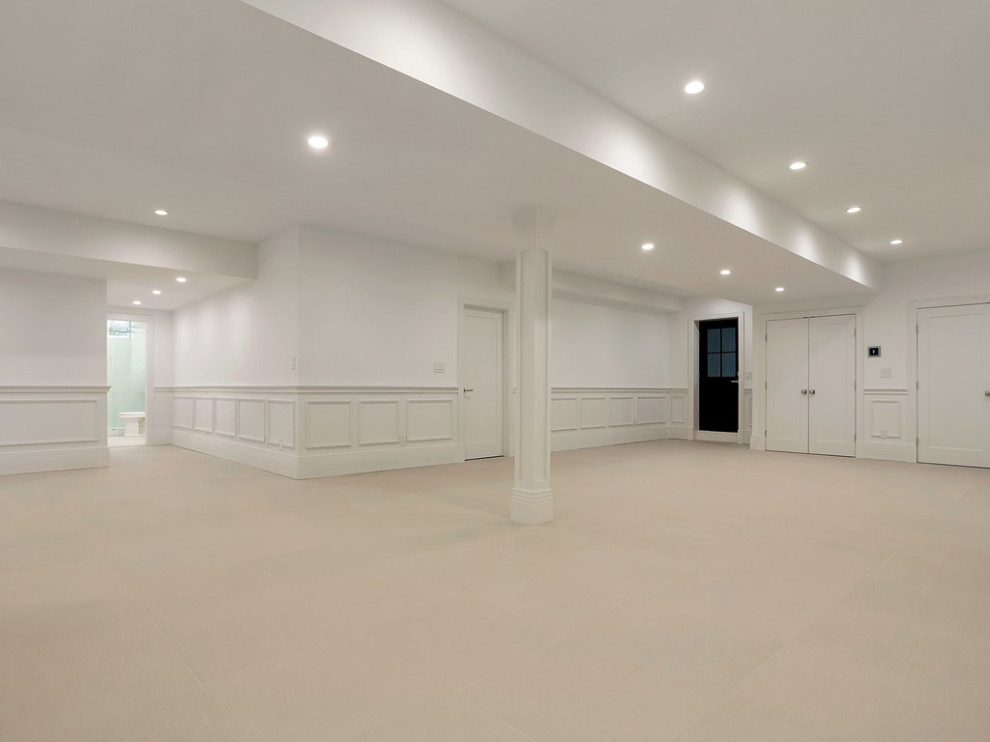 Expansive contemporary walk-out basement in New York with white walls, ceramic flooring and beige floors.