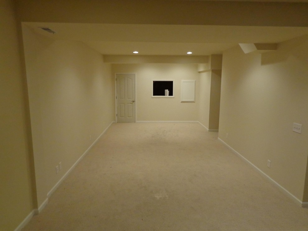 Photo of a large classic fully buried basement in Indianapolis with beige walls, carpet and no fireplace.