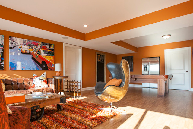 Large eclectic light wood floor and beige floor basement photo in Louisville with orange walls