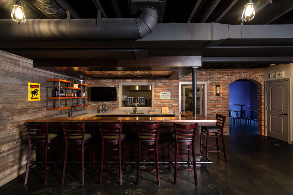 Inspiration for a large urban basement in Detroit with a home bar, concrete flooring and exposed beams.