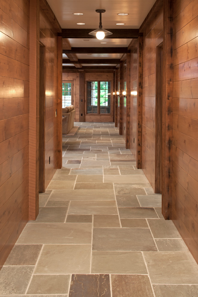 Inspiration for a rustic walk-out slate floor basement remodel in Minneapolis with brown walls