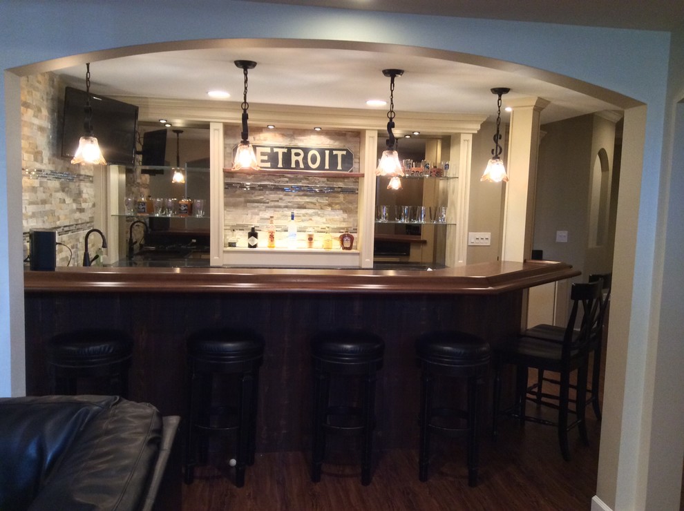 This is an example of a medium sized classic home bar in Detroit.