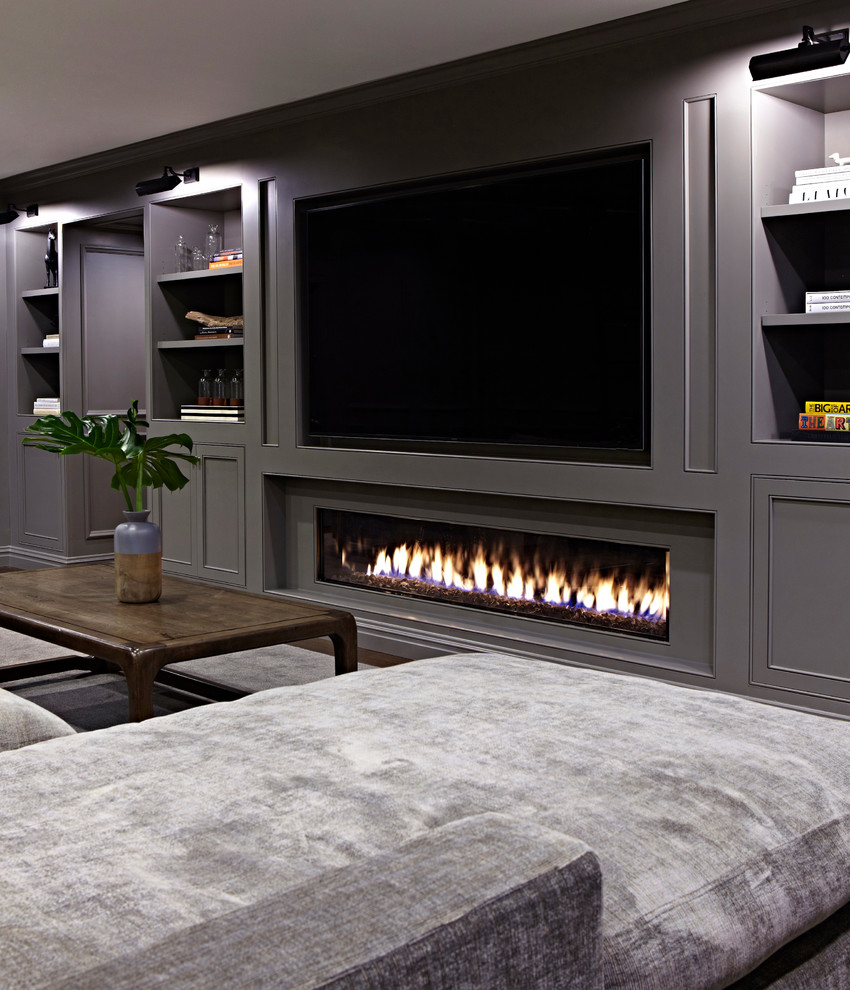 Basement - huge transitional underground dark wood floor basement idea in New York with gray walls and a ribbon fireplace