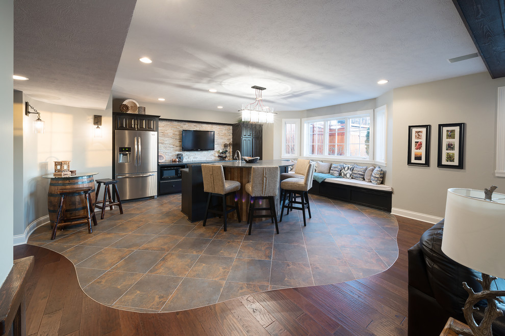 Inspiration for a large rustic look-out dark wood floor basement remodel in Indianapolis with gray walls and a standard fireplace