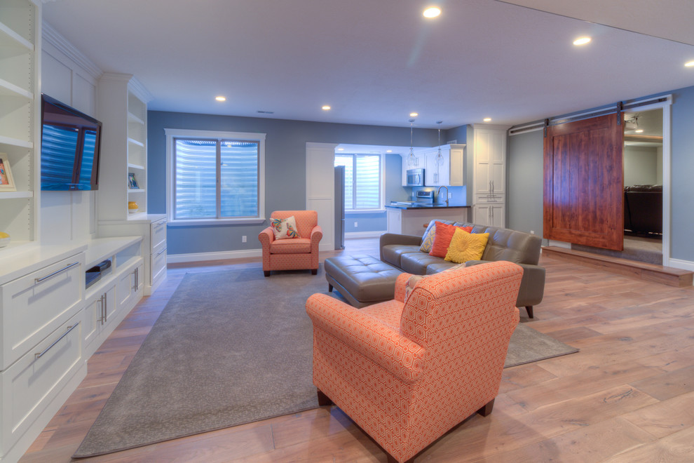Example of a large arts and crafts look-out medium tone wood floor basement design in Salt Lake City with gray walls and no fireplace