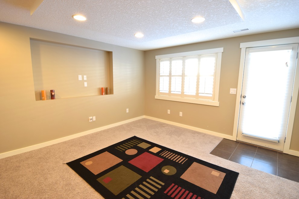 Small trendy walk-out carpeted basement photo in Calgary with no fireplace