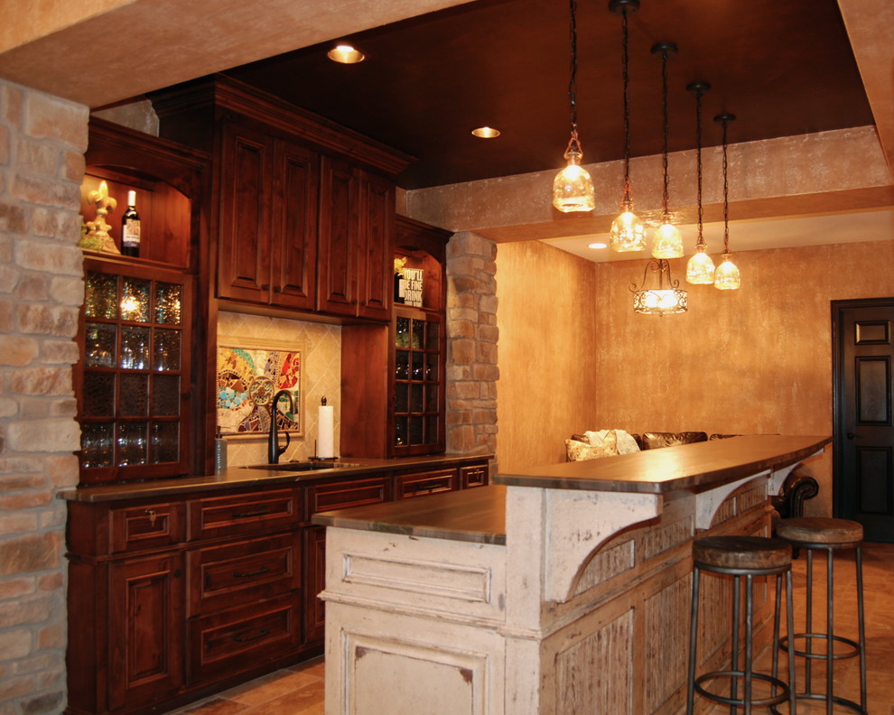 Inspiration for a large rustic home bar in Kansas City with travertine flooring.