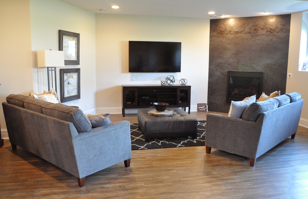 Inspiration for a large transitional underground vinyl floor basement remodel in Milwaukee with white walls, a standard fireplace and a tile fireplace