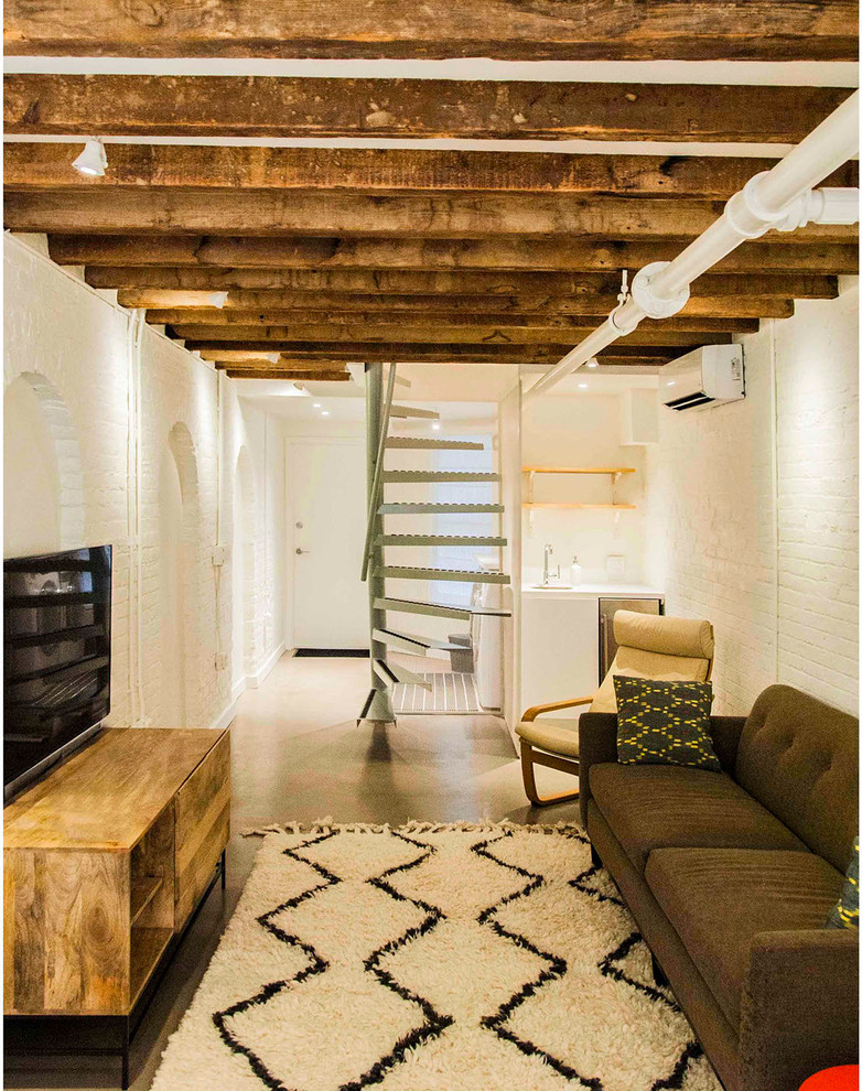 Basement - mid-sized industrial walk-out concrete floor basement idea in New York with white walls and no fireplace