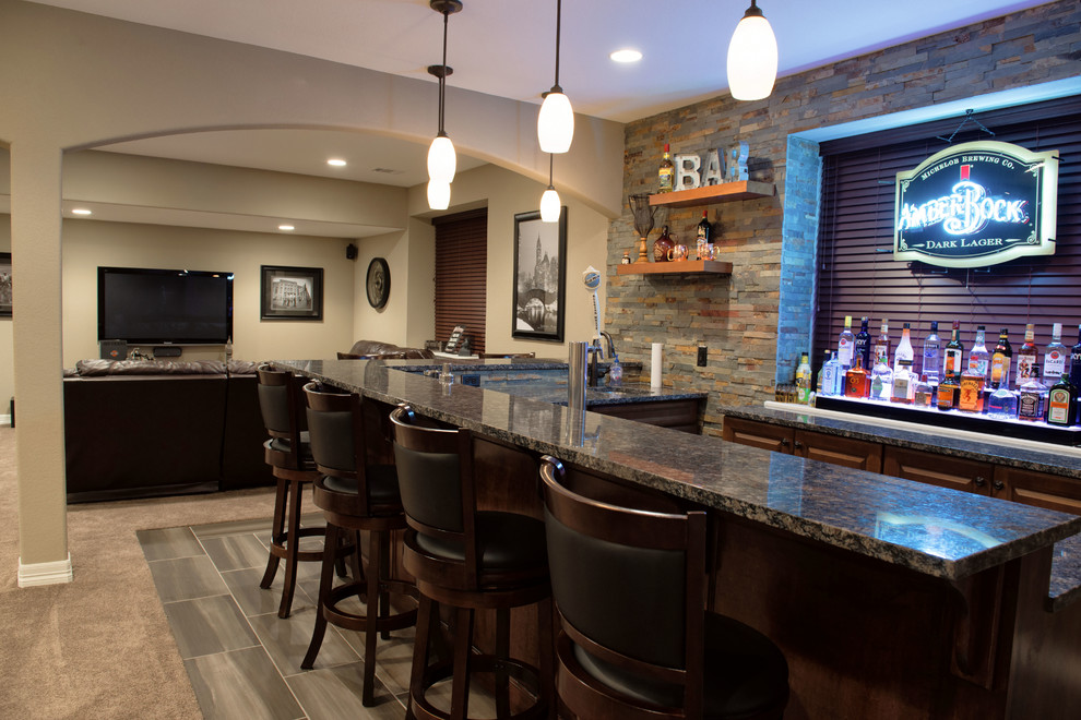 Large transitional walk-out porcelain tile basement photo in Denver with beige walls and a bar