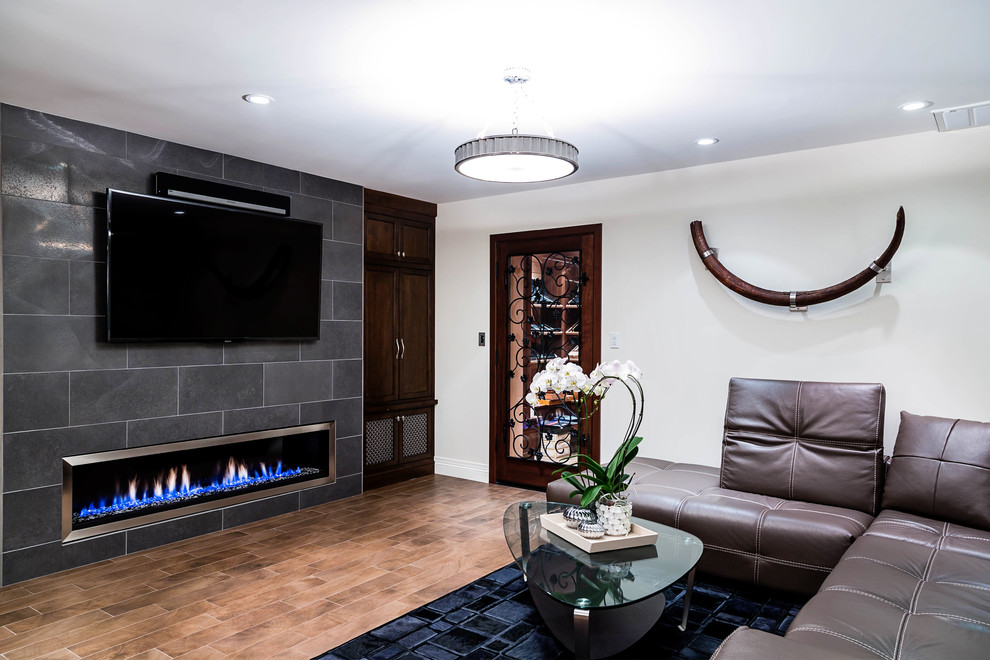 Photo of a medium sized contemporary look-out basement in Other with multi-coloured walls, porcelain flooring, a ribbon fireplace and brown floors.