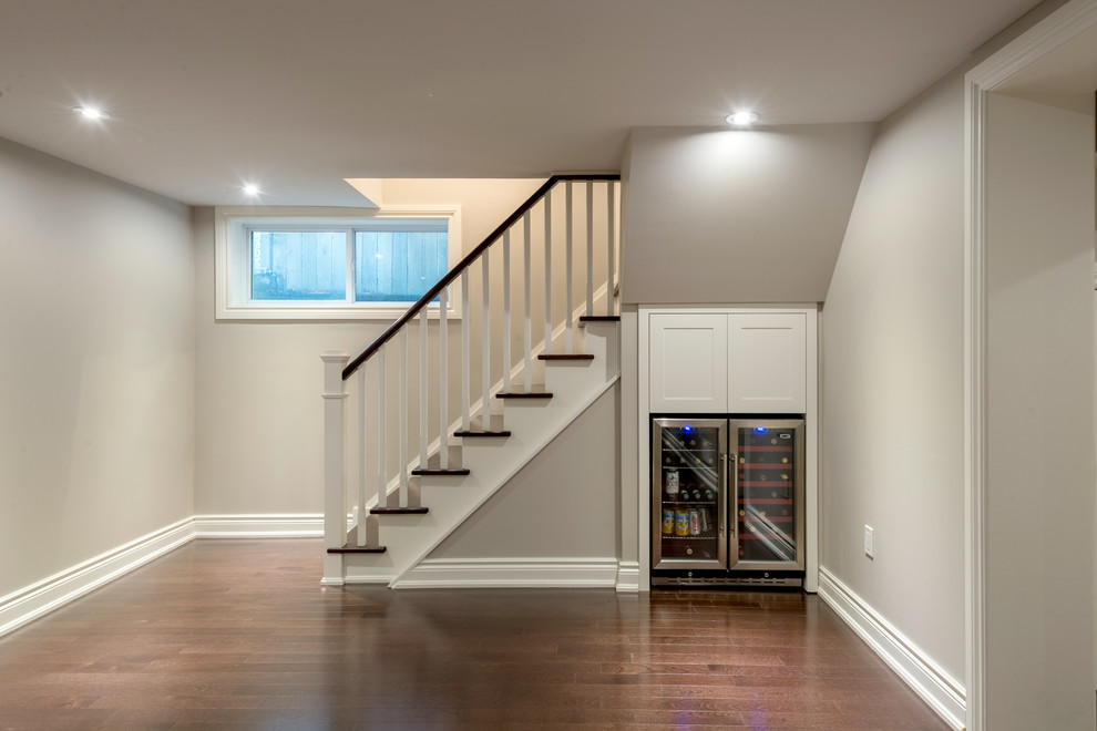 Inspiration for a small transitional look-out dark wood floor basement remodel in Toronto with gray walls and no fireplace
