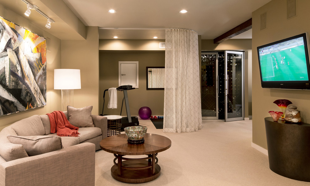 Example of a mid-sized transitional walk-out carpeted basement design in Portland with beige walls and no fireplace