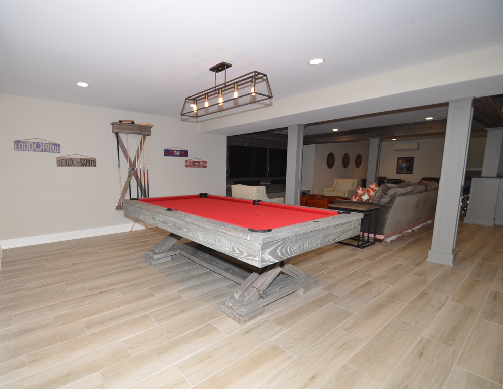 Example of a large transitional walk-out porcelain tile basement design in New York with gray walls