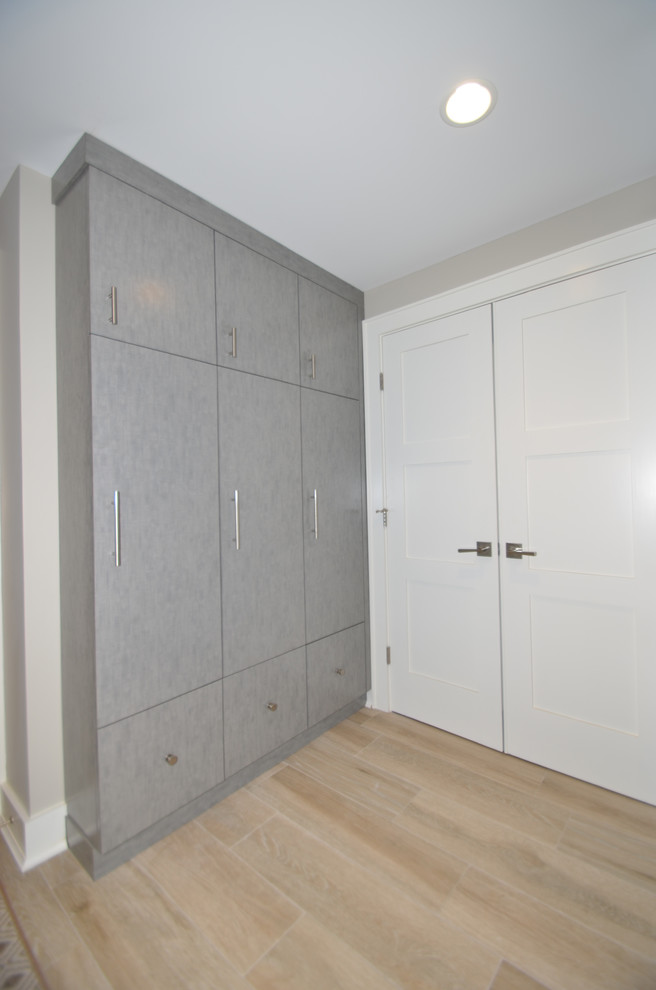 Diseño de sótano con puerta clásico renovado grande con paredes grises y suelo de baldosas de porcelana