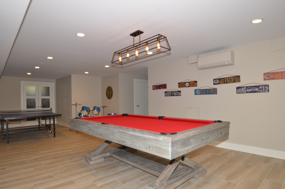 Basement - large transitional walk-out porcelain tile basement idea in New York with gray walls