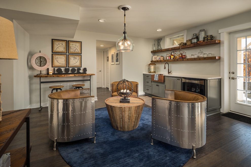Photo of an industrial home bar in DC Metro with dark hardwood flooring and brown floors.