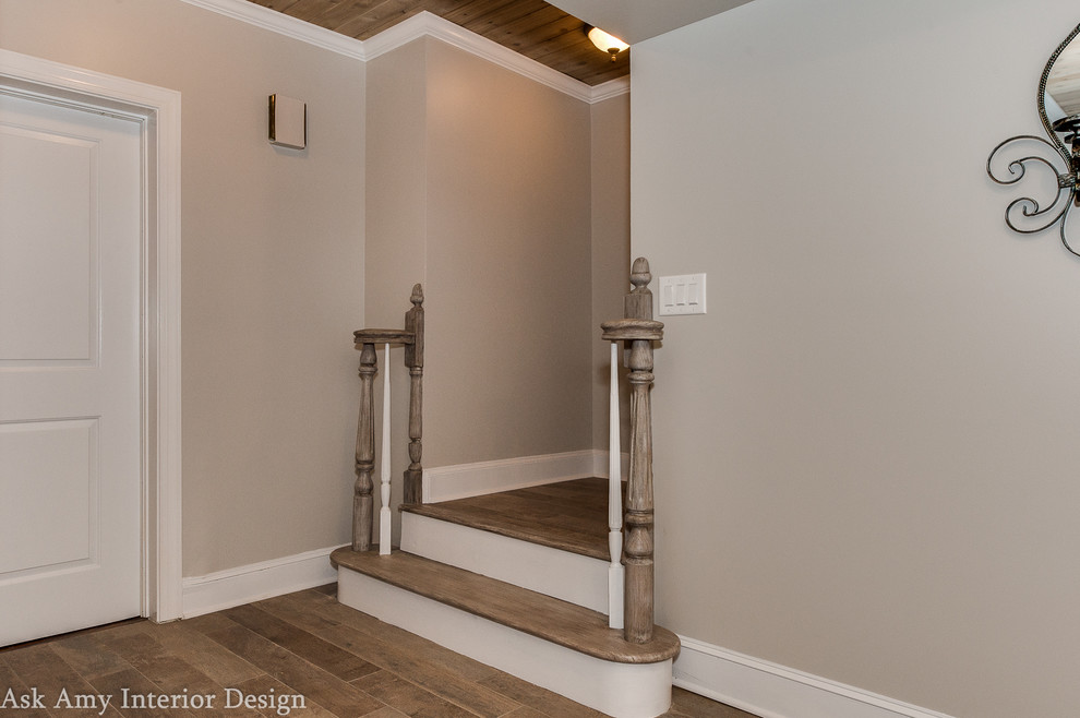 This is an example of an expansive traditional basement in Charlotte with grey walls and ceramic flooring.
