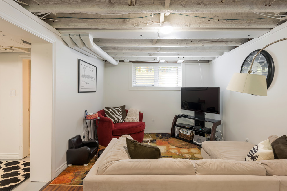 Photo of a small contemporary look-out basement in Toronto with white walls.