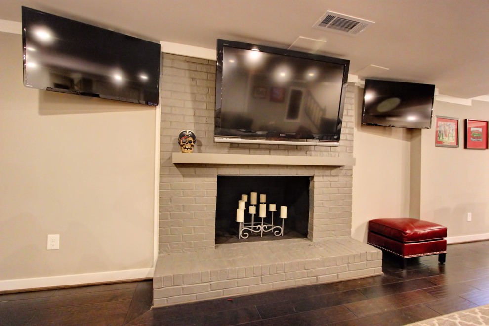 Large trendy walk-out ceramic tile basement photo in Atlanta with beige walls, a standard fireplace and a brick fireplace