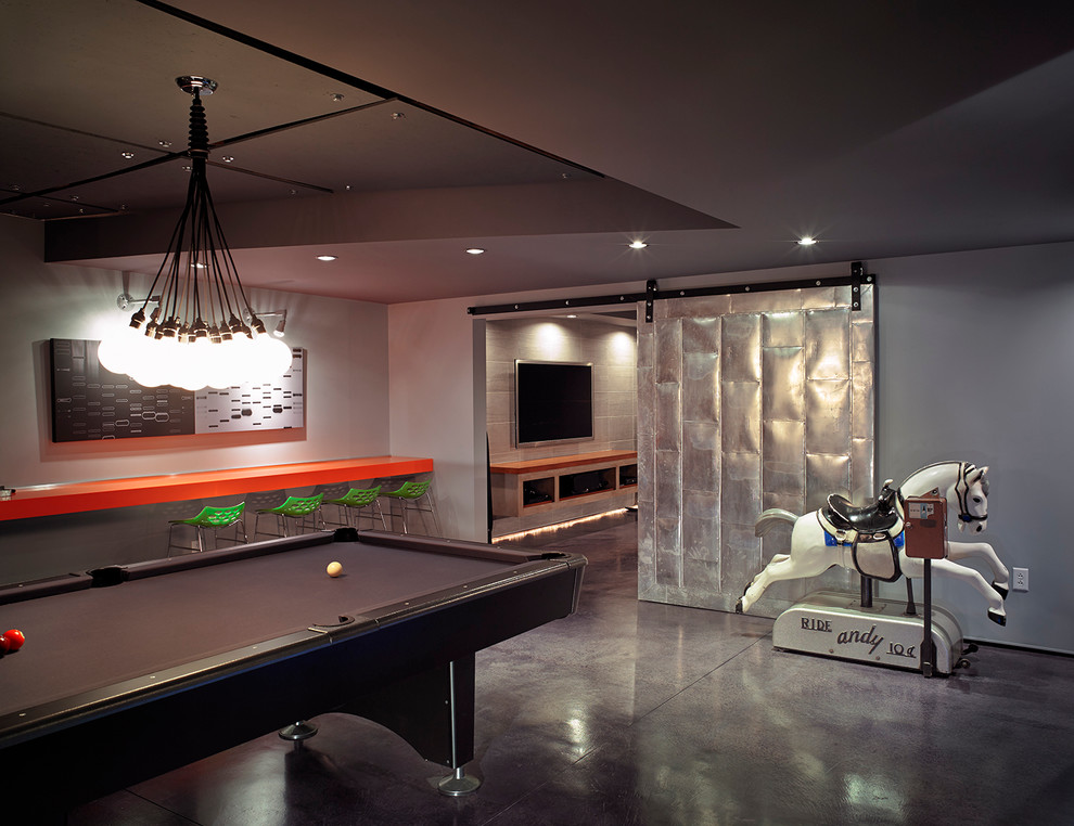 This is an example of a large contemporary games room in New York with grey floors.