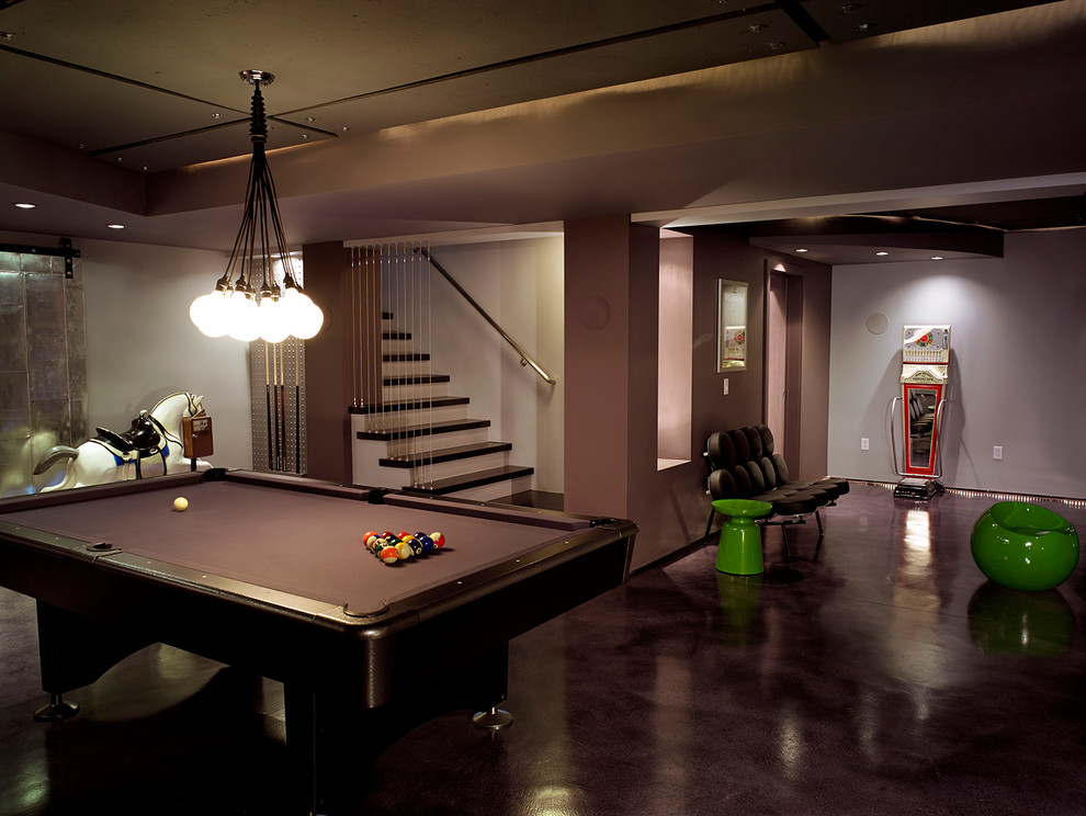 Large modern fully buried basement in New York with grey floors, grey walls and concrete flooring.