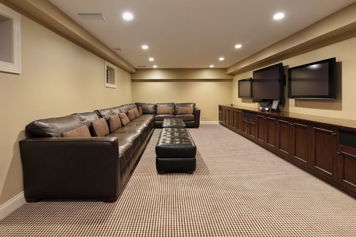 Example of a large transitional look-out medium tone wood floor basement design in New York with beige walls and no fireplace