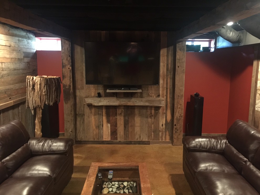 Large rustic fully buried basement in Other with red walls, concrete flooring, no fireplace and brown floors.