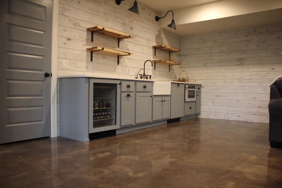This is an example of a traditional basement in Other with concrete flooring.