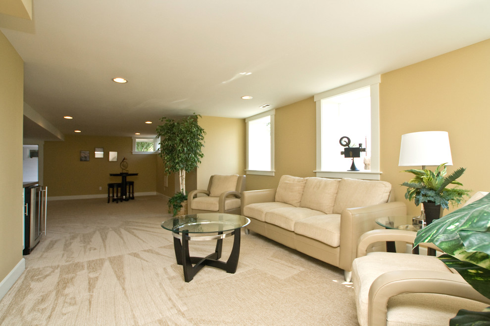 Huge transitional look-out carpeted basement photo in Portland with beige walls and no fireplace