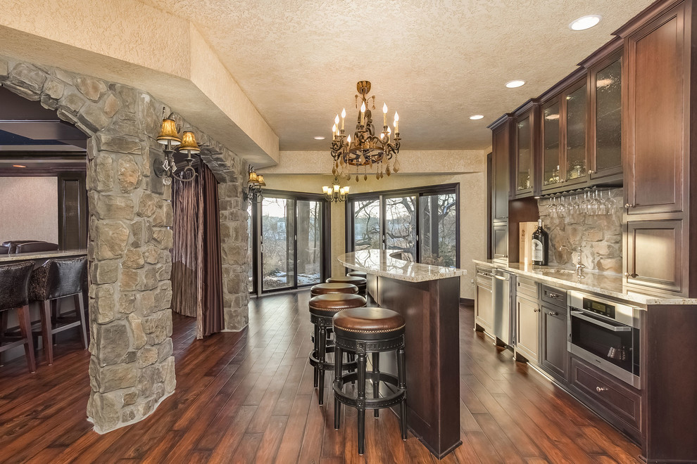 Inspiration for a medium sized classic look-out basement in Minneapolis with brown walls, dark hardwood flooring, a standard fireplace, a stone fireplace surround and brown floors.