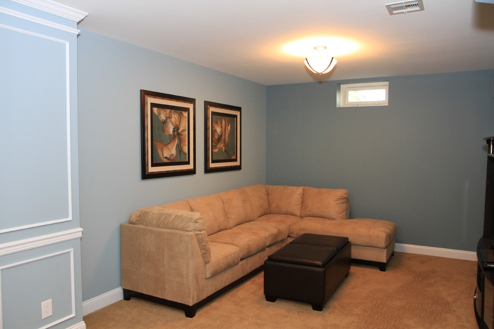 This is an example of an expansive classic look-out basement in Philadelphia with blue walls, carpet and no fireplace.