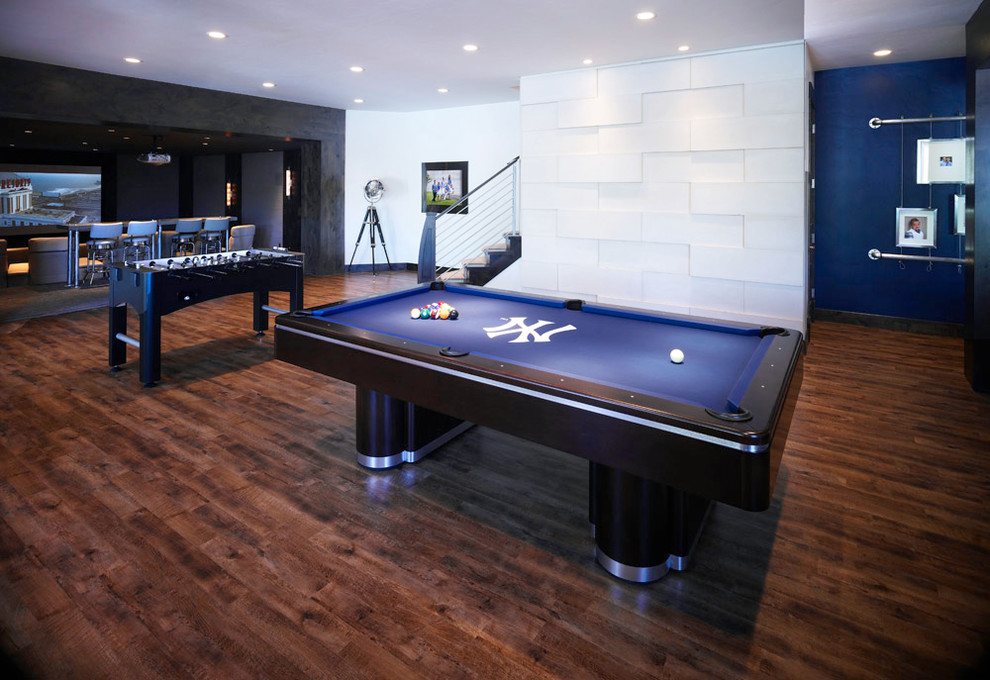 Example of a large trendy dark wood floor and brown floor basement game room design in Salt Lake City with white walls and no fireplace