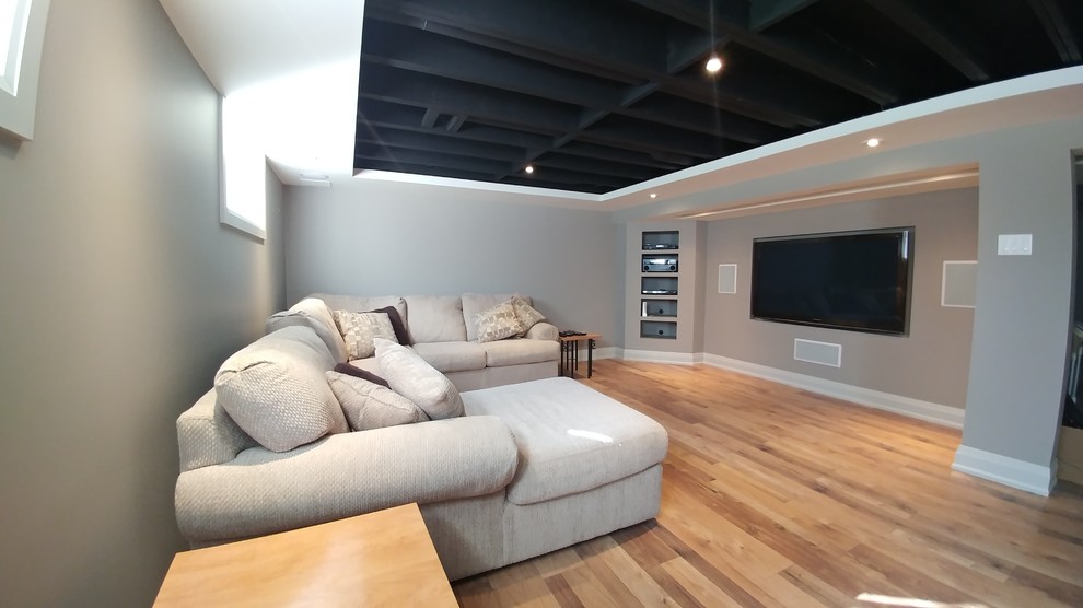 Design ideas for an expansive contemporary fully buried basement in Ottawa with grey walls, laminate floors and no fireplace.