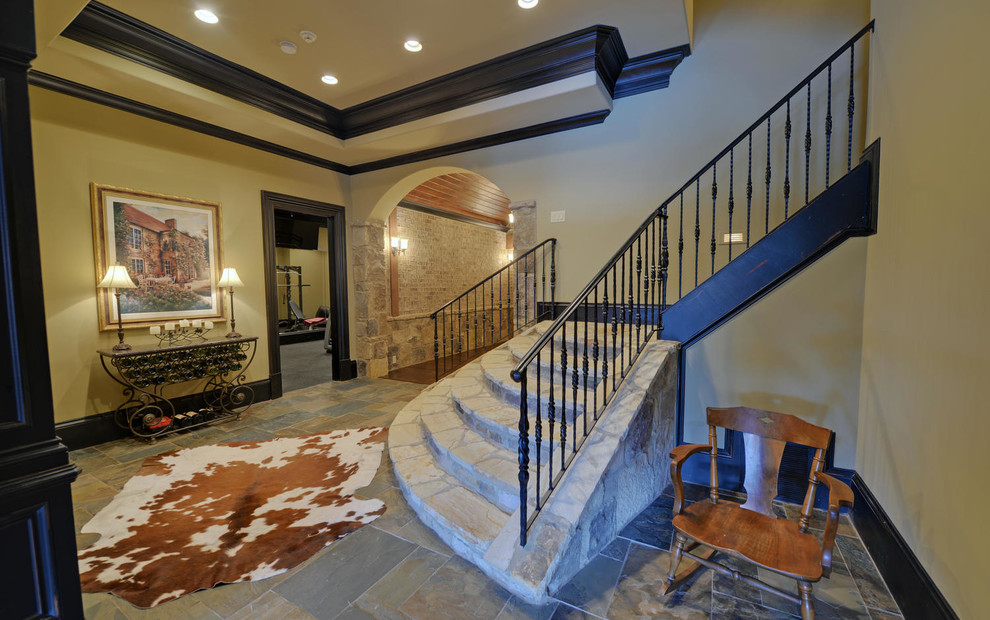 Example of a mid-sized mountain style slate floor and multicolored floor basement design in Atlanta with beige walls and no fireplace