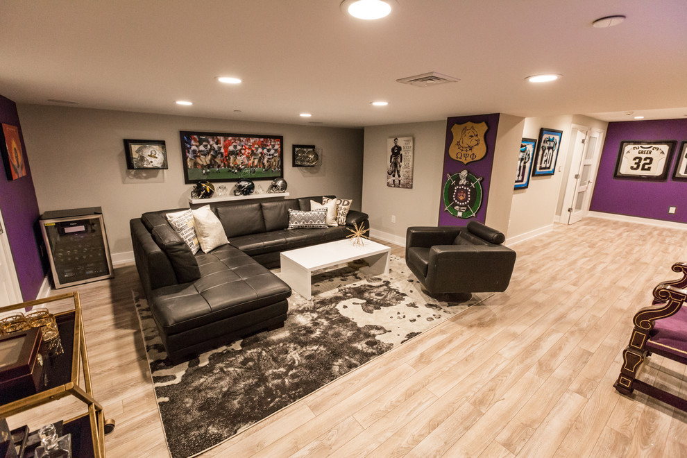 Photo of an expansive modern walk-out basement in Philadelphia with purple walls, light hardwood flooring and beige floors.