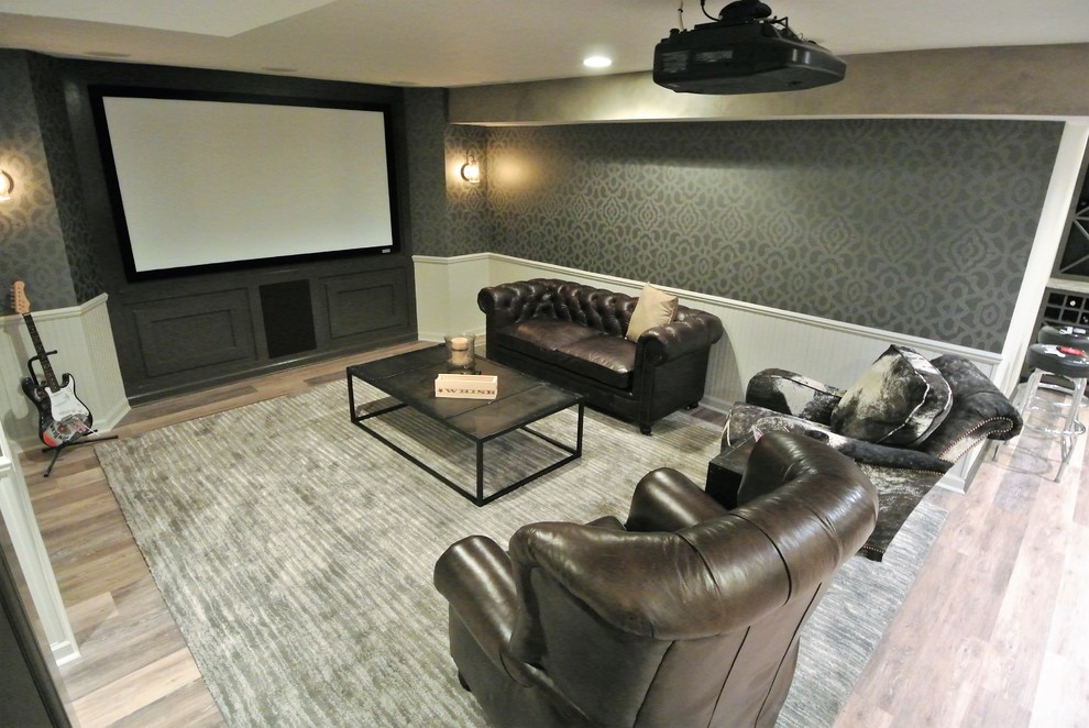 Home theater - small transitional medium tone wood floor home theater idea in Indianapolis with black walls