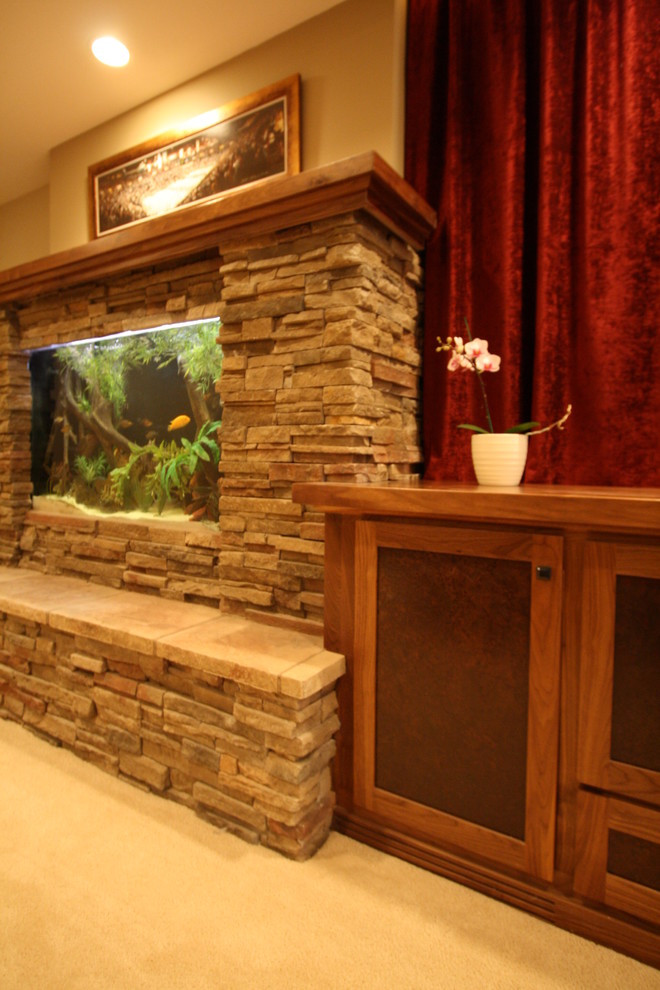 Photo of a medium sized traditional walk-out basement in Minneapolis with beige walls, carpet and a stone fireplace surround.