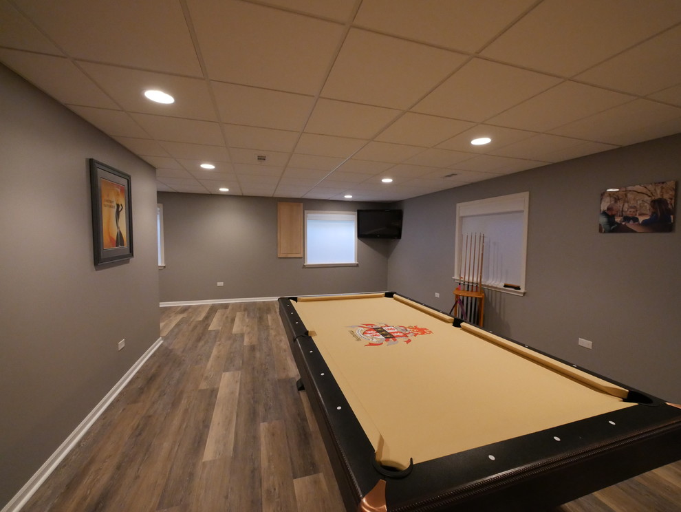 Inspiration for a large contemporary underground medium tone wood floor and brown floor basement remodel in Chicago with brown walls