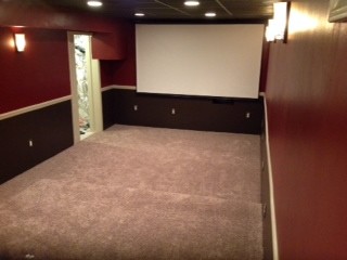 Inspiration for a small transitional underground carpeted and beige floor basement remodel in Newark with red walls