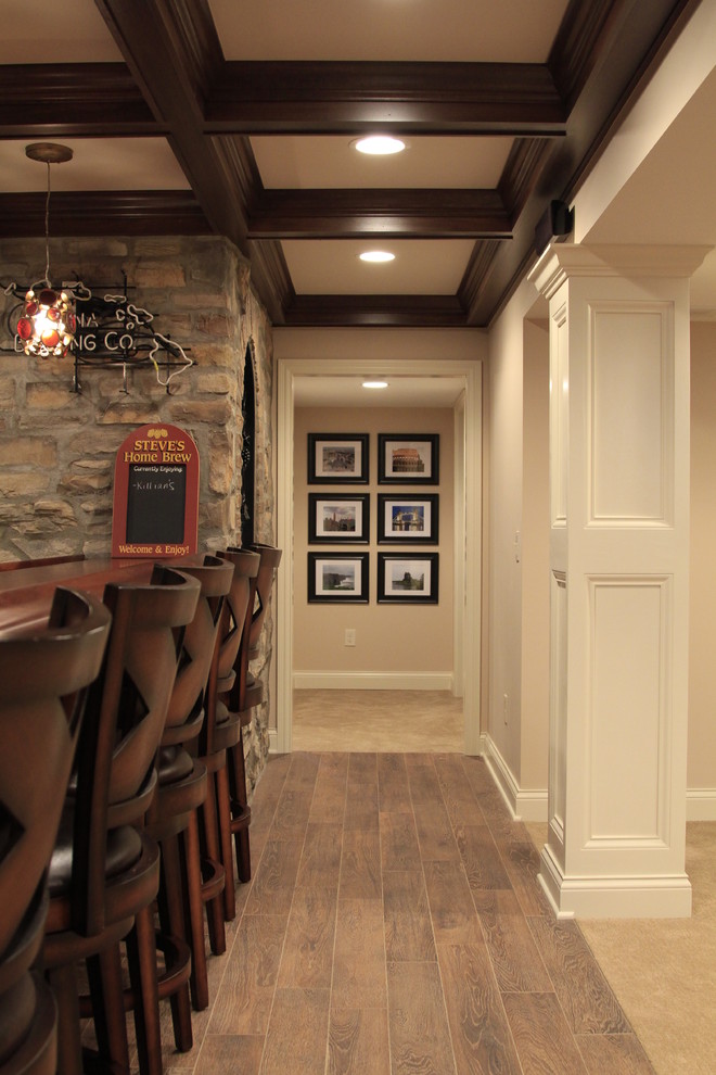 Mid-sized elegant underground medium tone wood floor basement photo in Columbus with beige walls