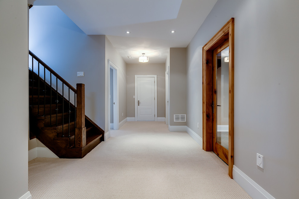 Traditional look-out basement in Toronto with carpet.